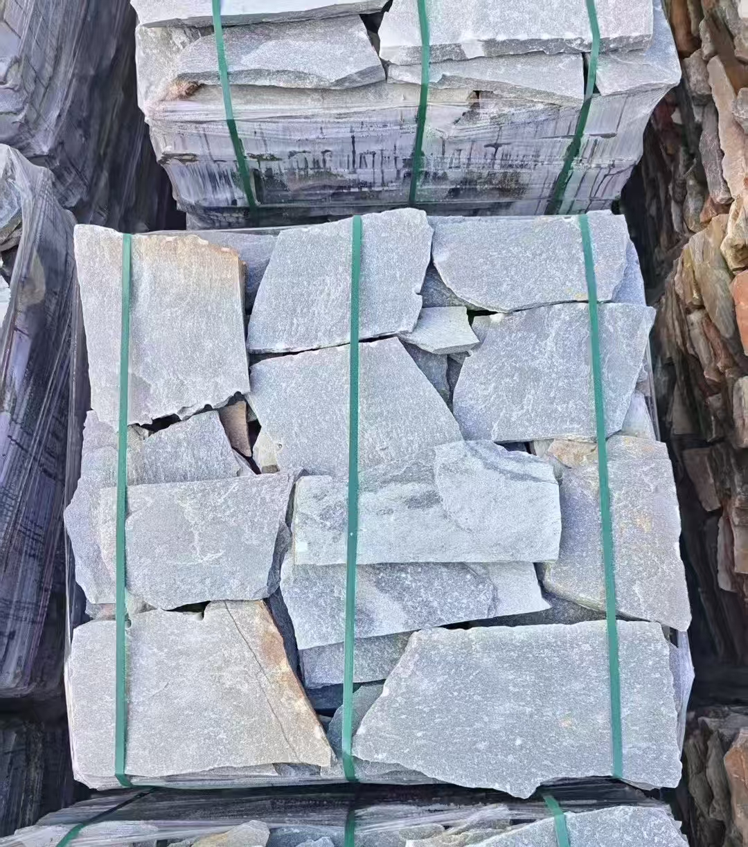 Naturally textured irregular slate paving stones in landscape setting