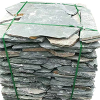 Naturally textured irregular slate paving stones in landscape setting
